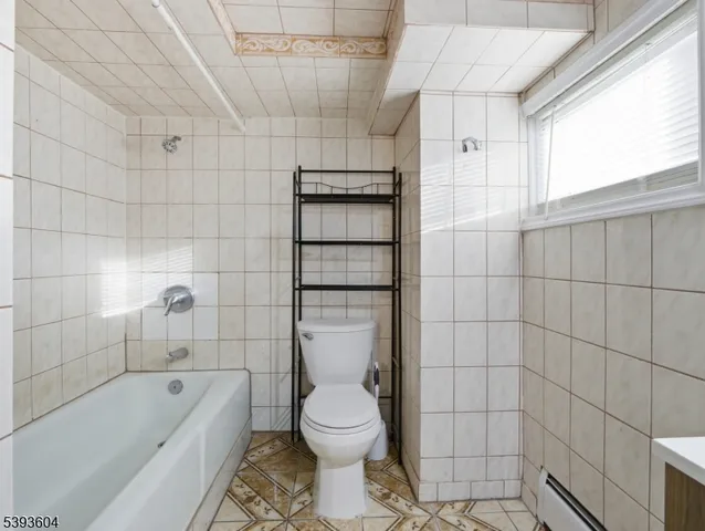 a bathroom with a sink shower and a mirror