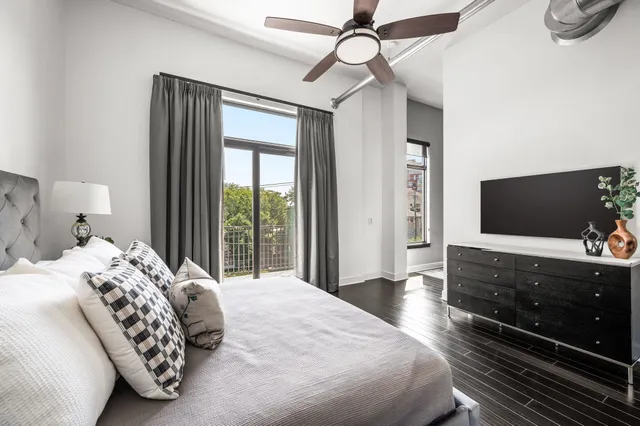 a bedroom with a bed and a large window