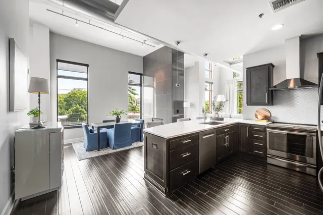 a large kitchen with a table and chairs