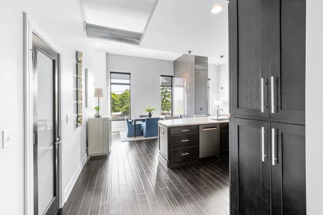 a kitchen with stainless steel appliances granite countertop a sink refrigerator and microwave