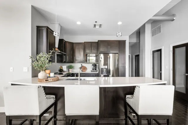 a view of a dining room with furniture a chandelier and wooden floor