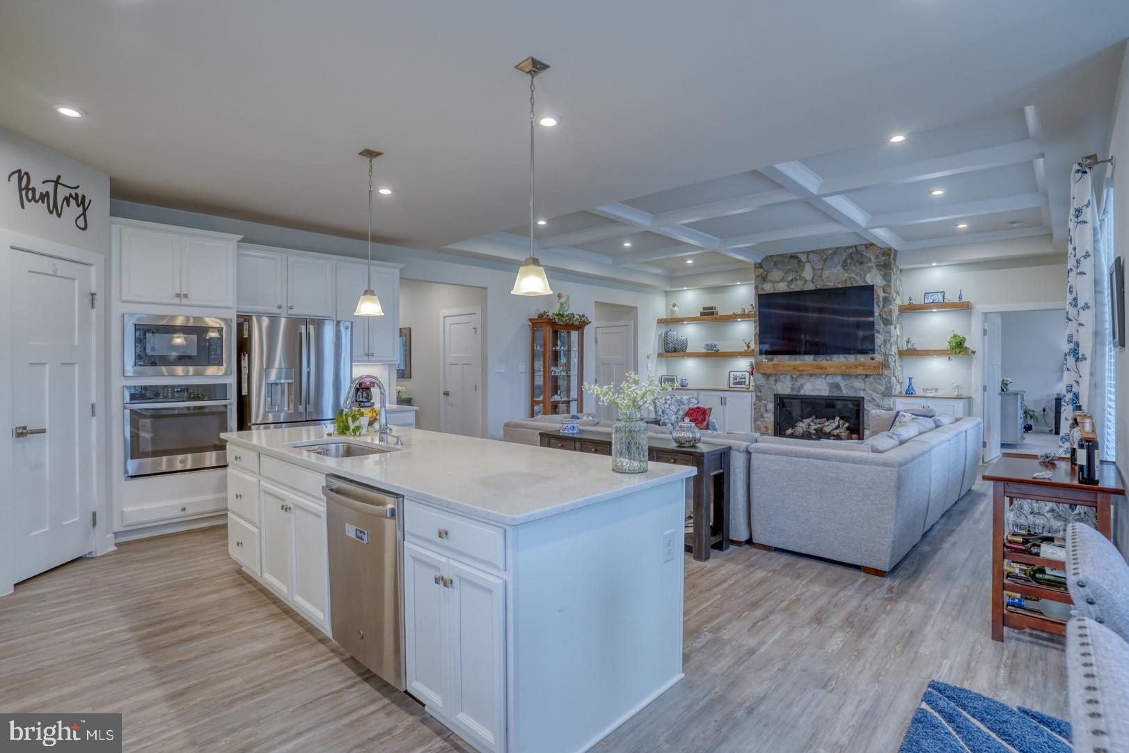 24077 Caldwell Circle Lewes, DE 19958 - Photo 20 of 60 a large kitchen with stainless steel appliances lots of counter space and wooden floor
