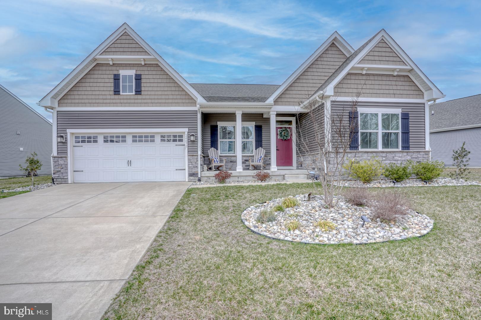 24077 Caldwell Circle Lewes, DE 19958 - Photo 2 of 60 a front view of a house with a yard