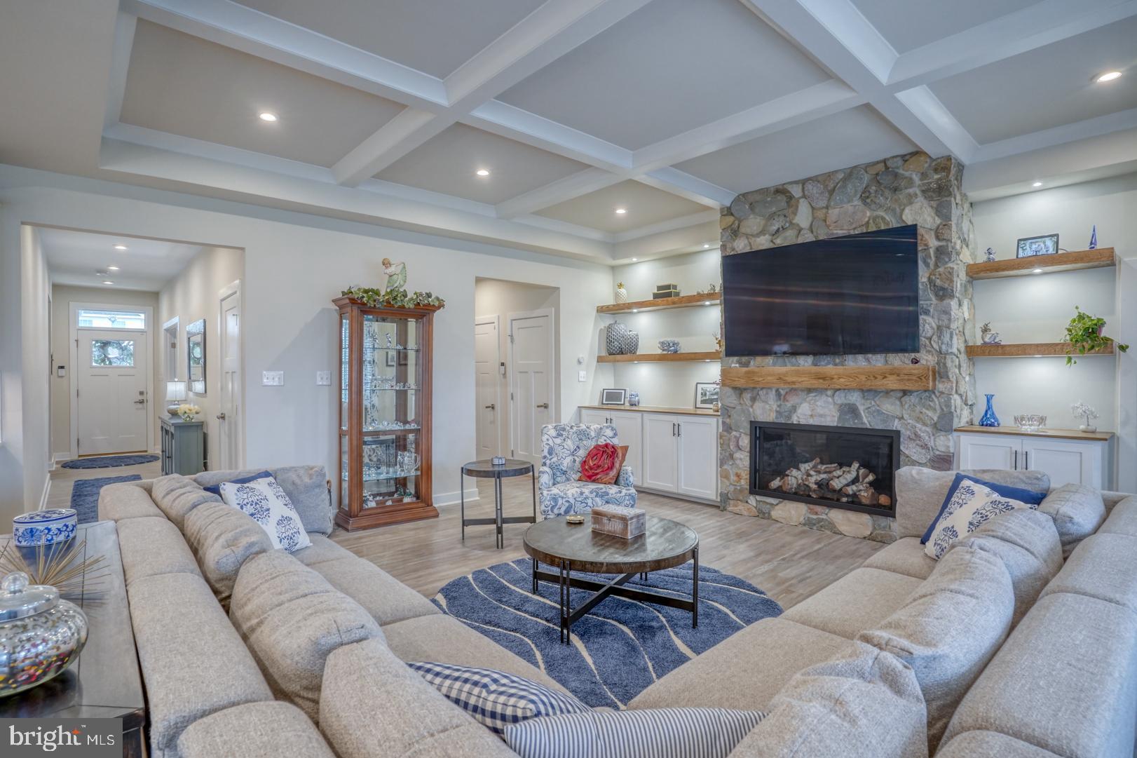 24077 Caldwell Circle Lewes, DE 19958 - Photo 21 of 60 a living room with furniture a fireplace and a flat screen tv