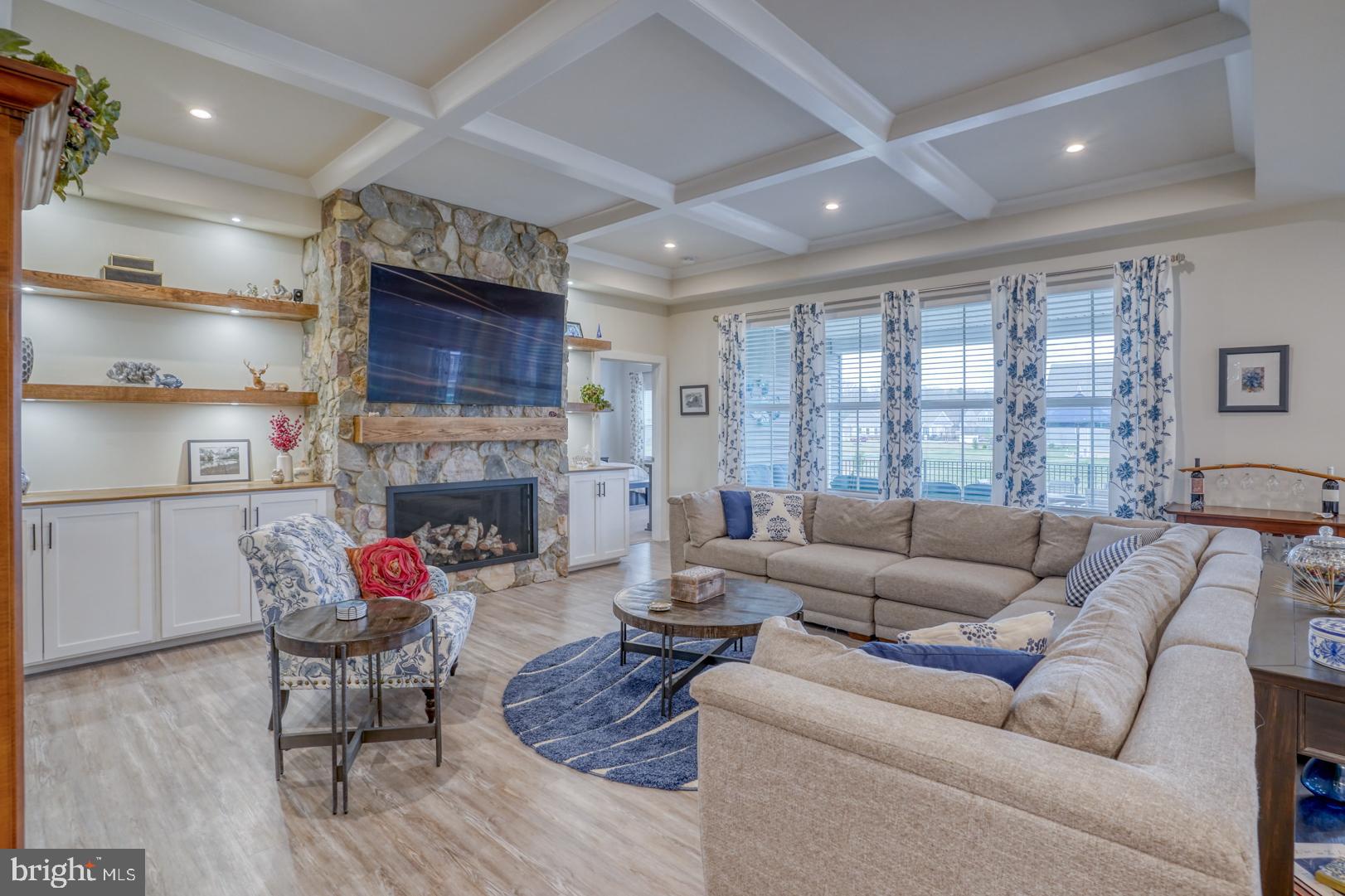 24077 Caldwell Circle Lewes, DE 19958 - Photo 22 of 60 a living room with furniture a fireplace and a large window