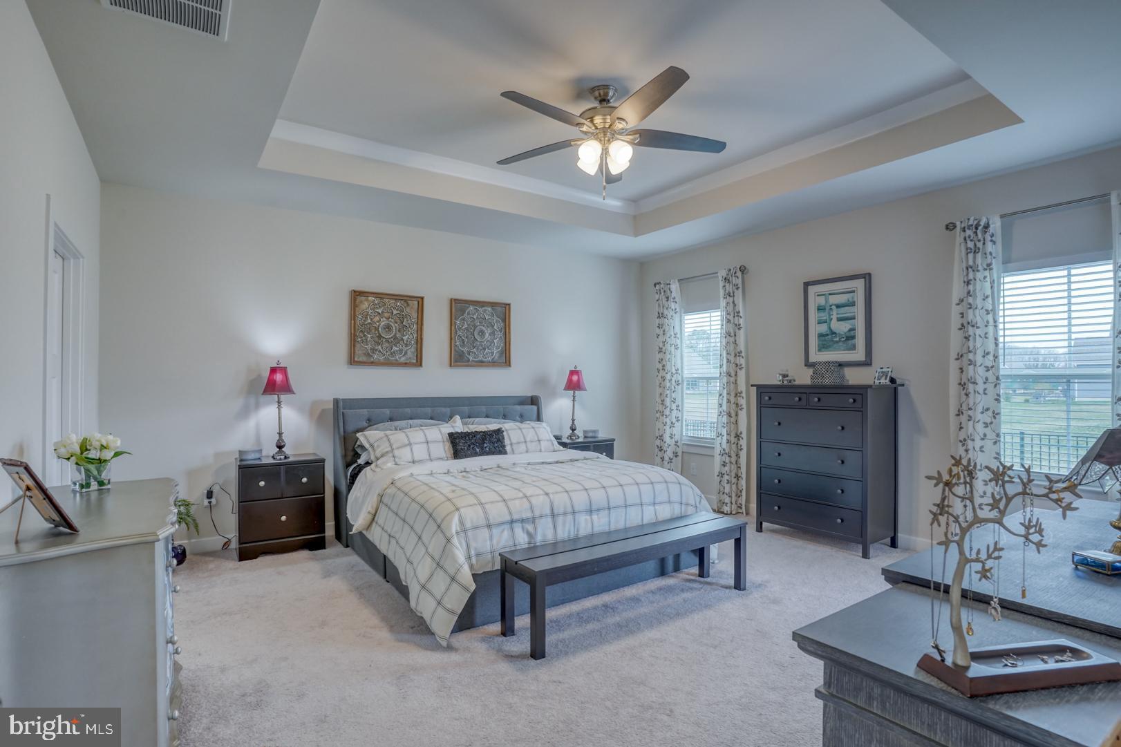24077 Caldwell Circle Lewes, DE 19958 - Photo 31 of 60 a bedroom with a bed and dresser with mirror