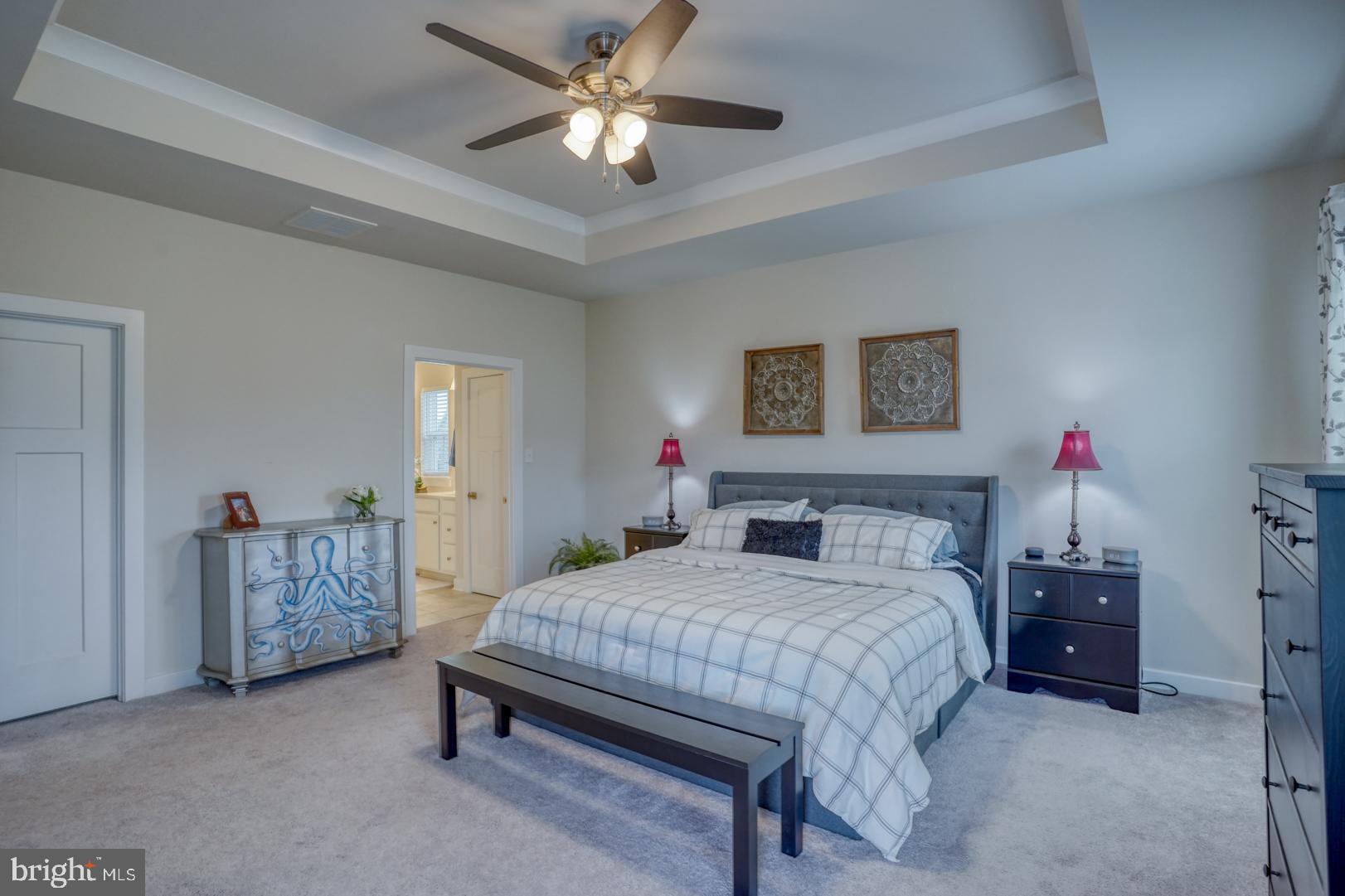 24077 Caldwell Circle Lewes, DE 19958 - Photo 32 of 60 a bedroom with a bed chandelier and a window