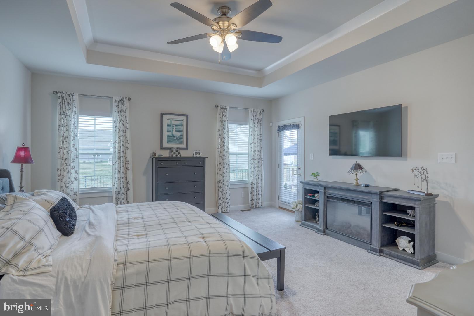 24077 Caldwell Circle Lewes, DE 19958 - Photo 33 of 60 a bedroom with a bed and a flat tv screen on dresser