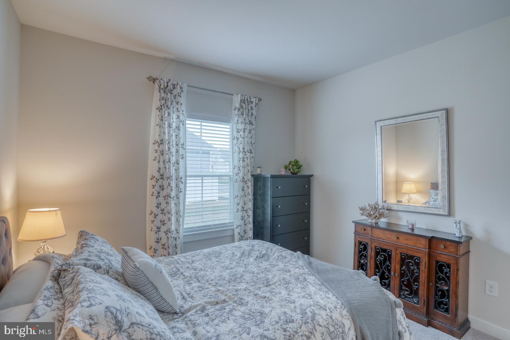 24077 Caldwell Circle Lewes, DE 19958 - Photo 38 of 60 a bedroom with a bed and a dresser in it