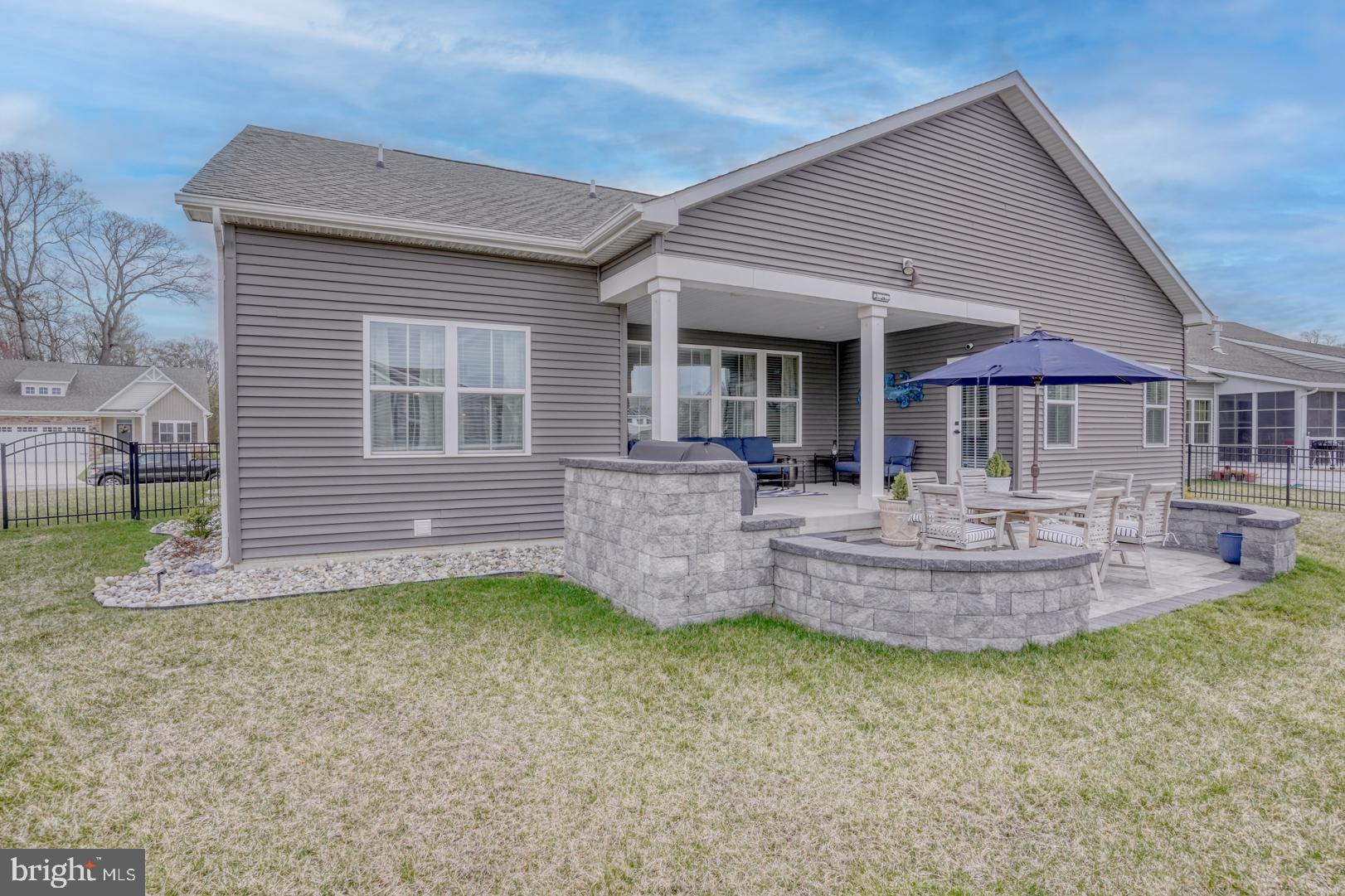 24077 Caldwell Circle Lewes, DE 19958 - Photo 6 of 60 a front view of a house with a garden and patio