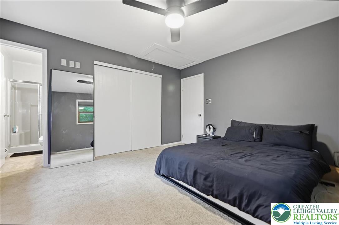 520 Highland Hill Road Jim Thorpe, PA 18235 - Photo 27 of 83 A comfortable bedroom features plush carpeting and a modern ceiling fan, offering a serene personal retreat.