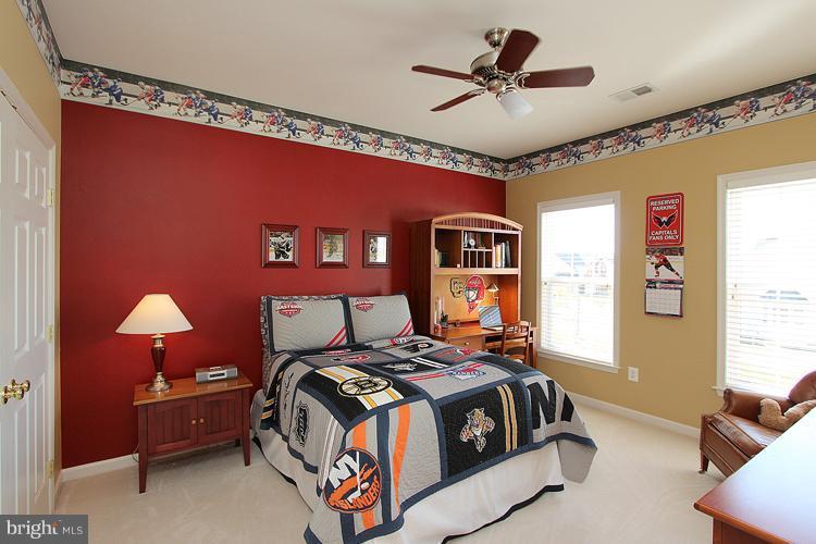 18419 Cornflower Road Boyds, MD 20841 - Photo 22 of 30 a bedroom with bed and a chandelier