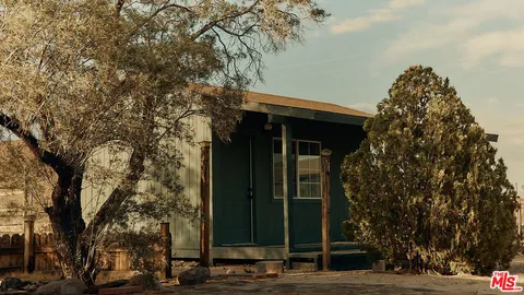 a view of a house with a tree