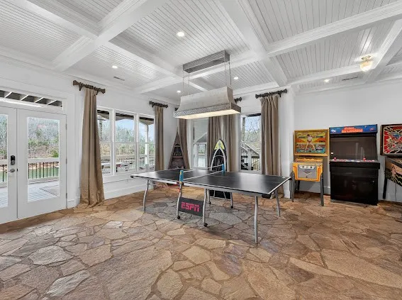 a view of a patio with table and chairs and wooden floor