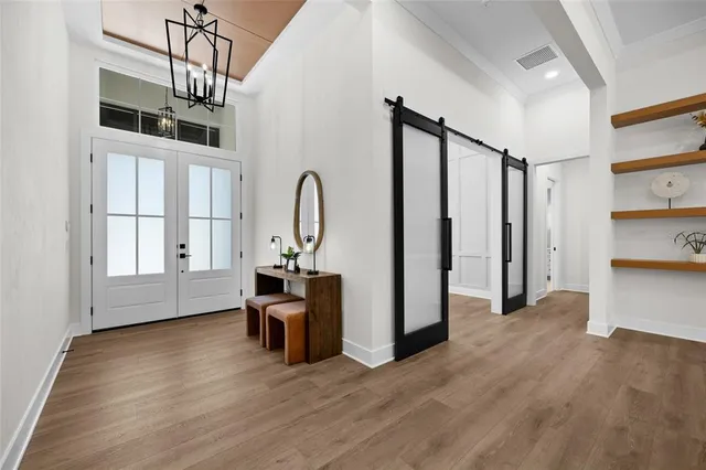a view of a room with wooden floor and windows