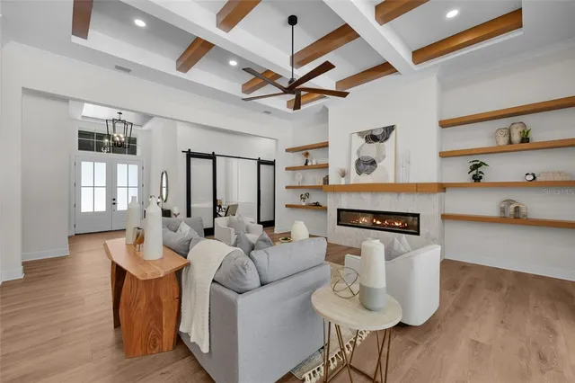 a living room with furniture a fireplace and a window