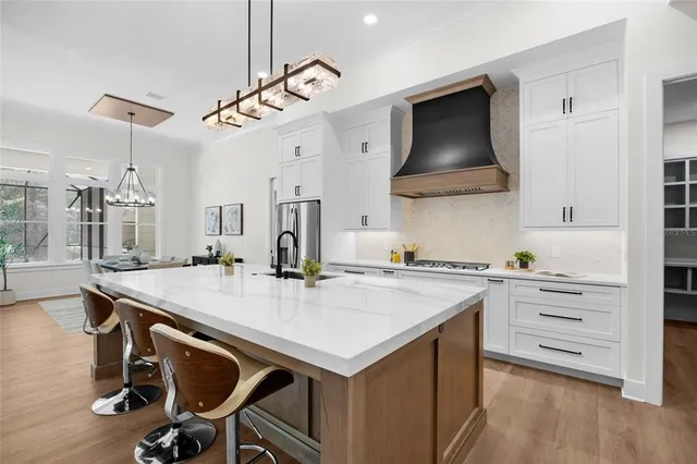 a kitchen with a stove a refrigerator and a sink