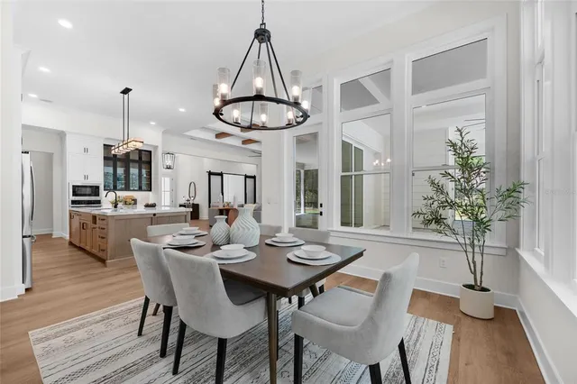 a view of a dining room with furniture window and wooden floor