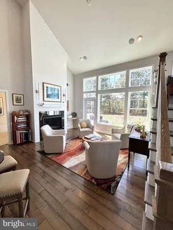 a living room with furniture a fireplace and a large window