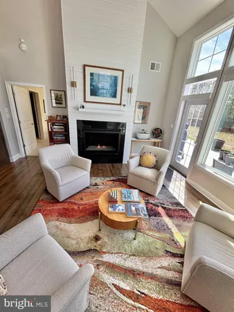 a living room with furniture large window and a fireplace
