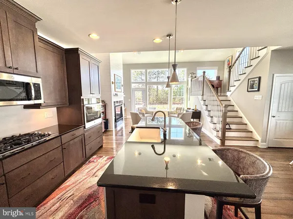 a large kitchen with stainless steel appliances granite countertop a lot of counter space and a refrigerator