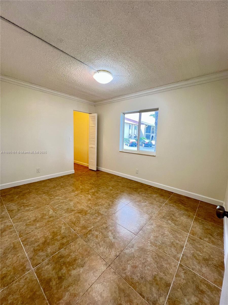 340 Pine Ridge Circle, Unit D1 Greenacres, FL 33463 - Photo 12 of 25 a view of an empty room with a window