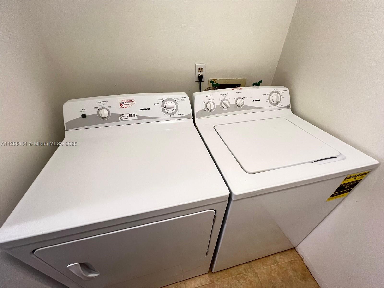 340 Pine Ridge Circle, Unit D1 Greenacres, FL 33463 - Photo 13 of 25 a utility room with dryer and washer