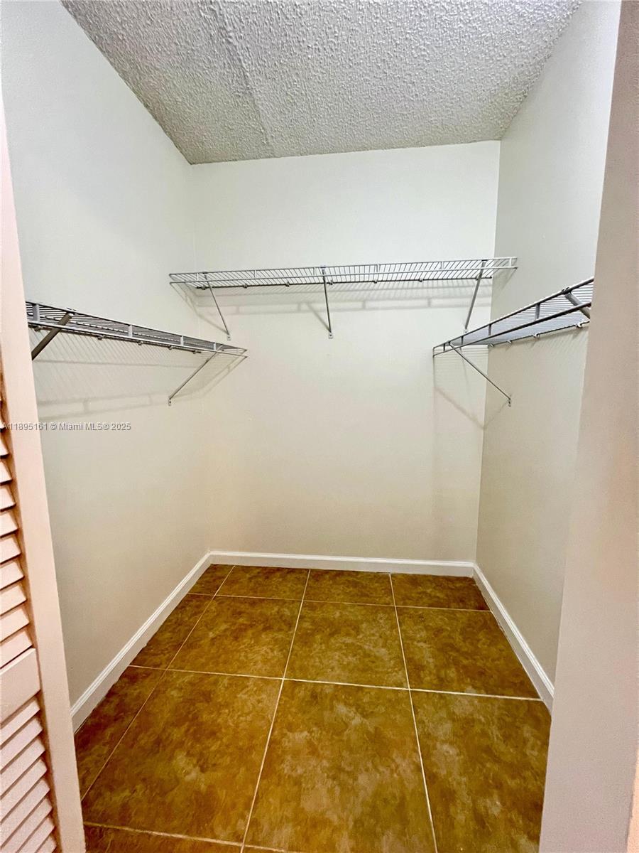340 Pine Ridge Circle, Unit D1 Greenacres, FL 33463 - Photo 15 of 25 a view of a room with racks on the wall