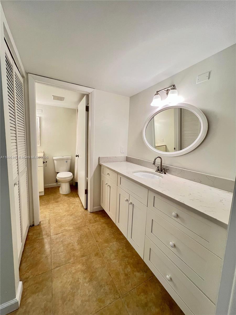 340 Pine Ridge Circle, Unit D1 Greenacres, FL 33463 - Photo 16 of 25 a spacious bathroom with a double vanity sink and a mirror