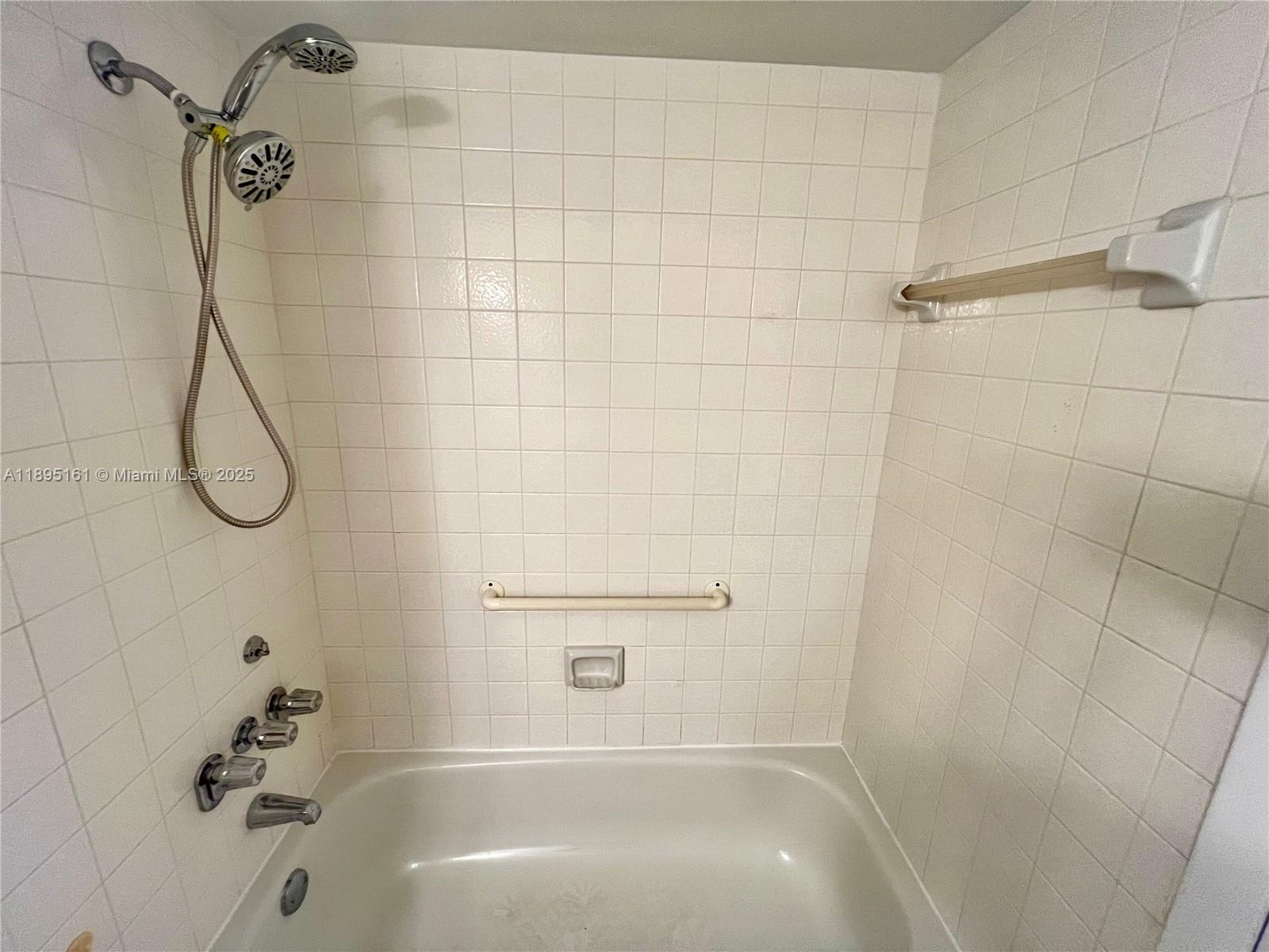 340 Pine Ridge Circle, Unit D1 Greenacres, FL 33463 - Photo 18 of 25 a bathroom with a shower and a bath tub
