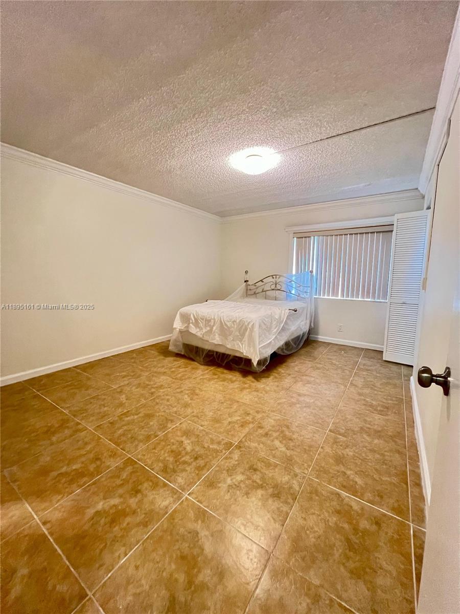 340 Pine Ridge Circle, Unit D1 Greenacres, FL 33463 - Photo 19 of 25 a bedroom with a bed and a window in it