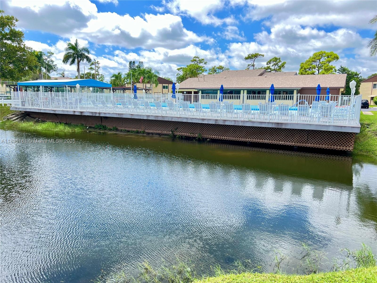 340 Pine Ridge Circle, Unit D1 Greenacres, FL 33463 - Photo 25 of 25 a view of a lake with a house