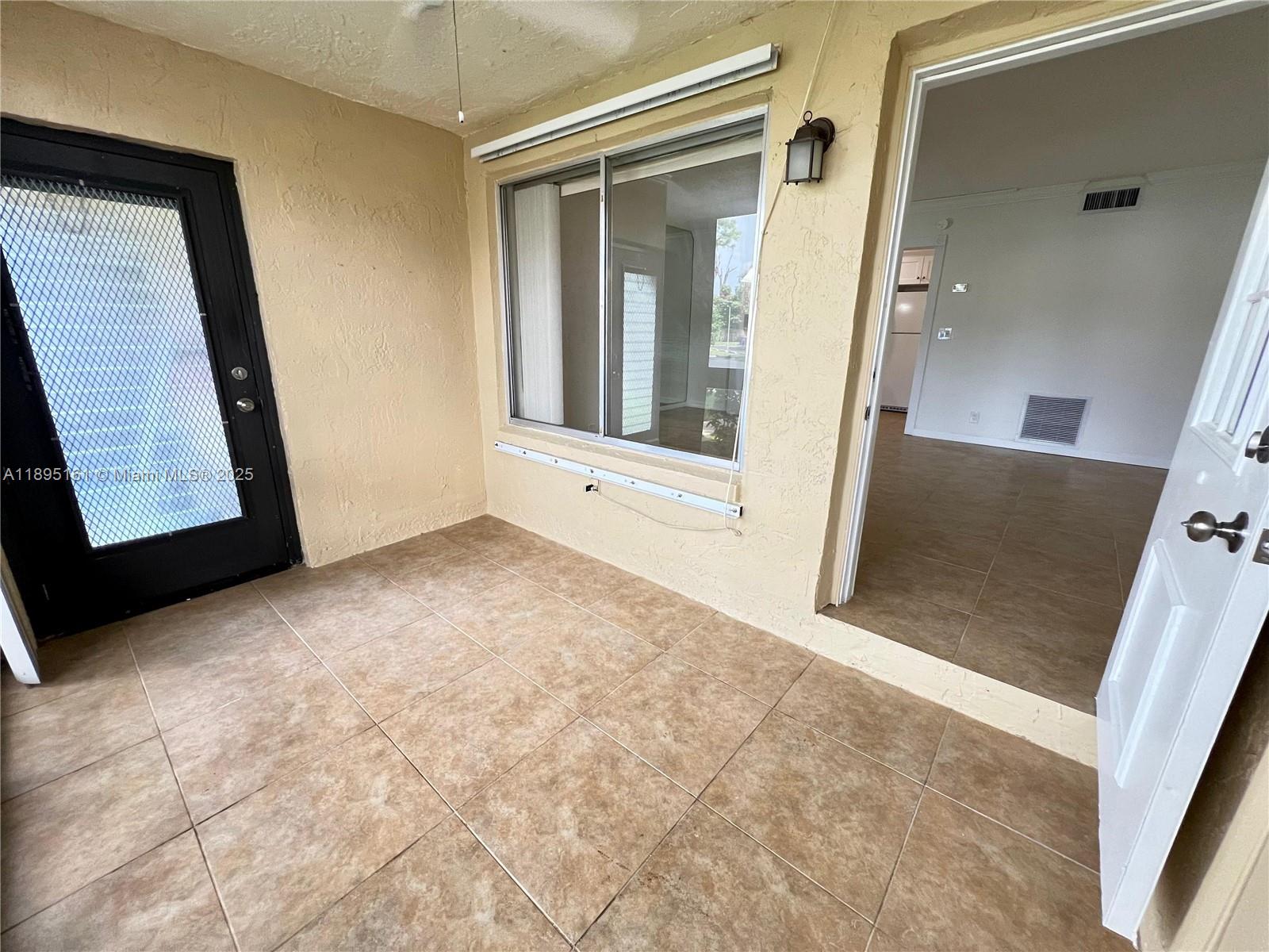 340 Pine Ridge Circle, Unit D1 Greenacres, FL 33463 - Photo 8 of 25 a view of an empty room with a window