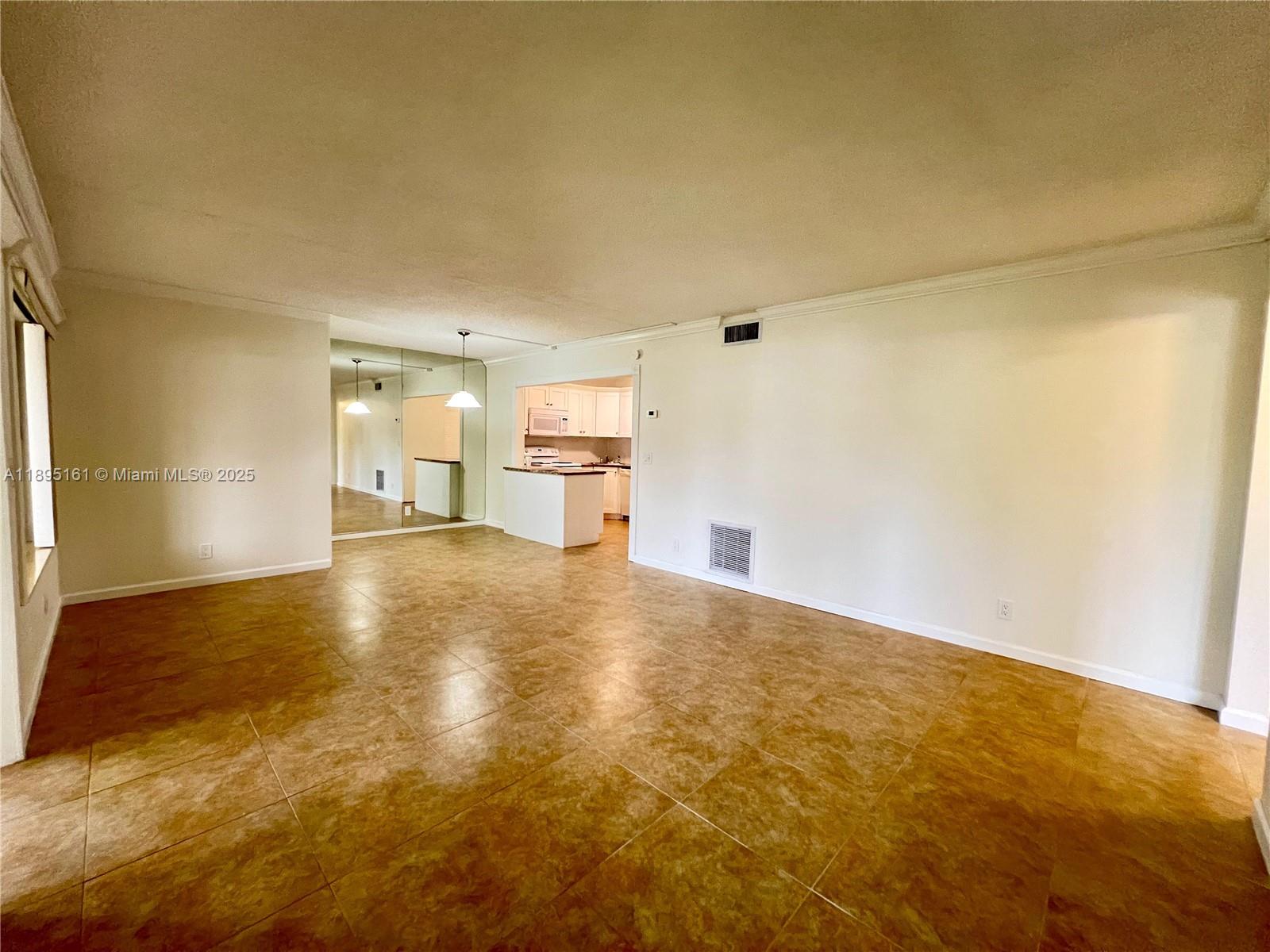 340 Pine Ridge Circle, Unit D1 Greenacres, FL 33463 - Photo 9 of 25 a view of empty room with wooden floor