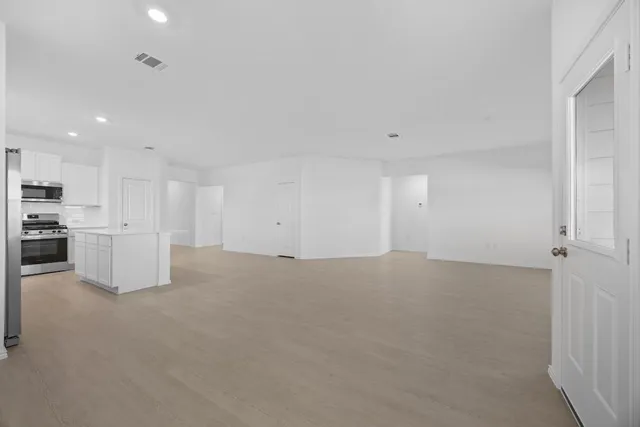 a view of a livingroom and a kitchen