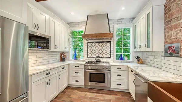 a kitchen with stainless steel appliances cabinets and a counter top space