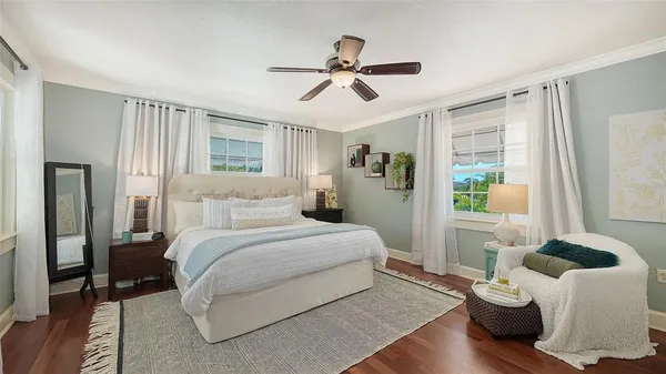 a bedroom with a bed and a chandelier