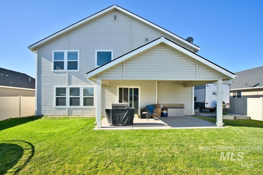 12656 Brun Street Caldwell, ID 83607 - Photo 32 of 39 Back of property with a fenced backyard and a patio area