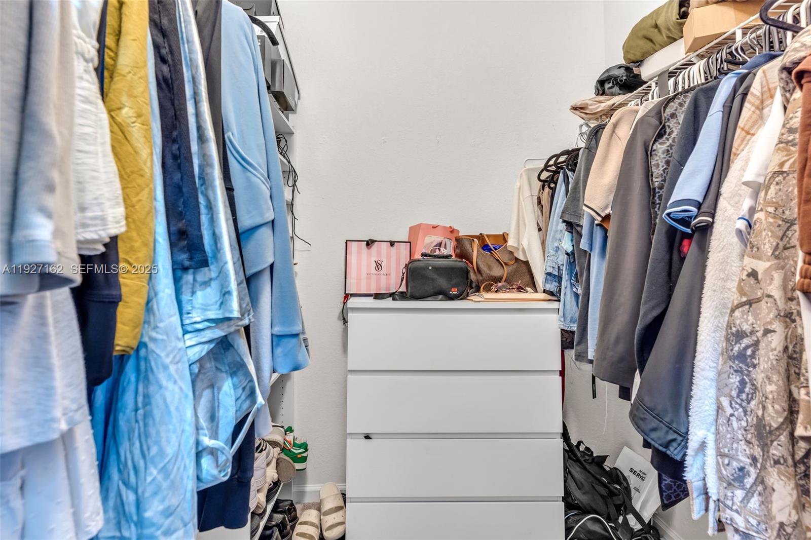 11833 Southwest 250th Terrace Homestead, FL 33032 - Photo 16 of 38 a view of walk in closet with clothes and shoes