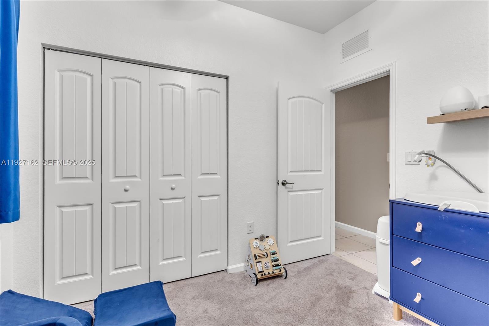 11833 Southwest 250th Terrace Homestead, FL 33032 - Photo 19 of 38 a view of a room with a dresser and wooden floor