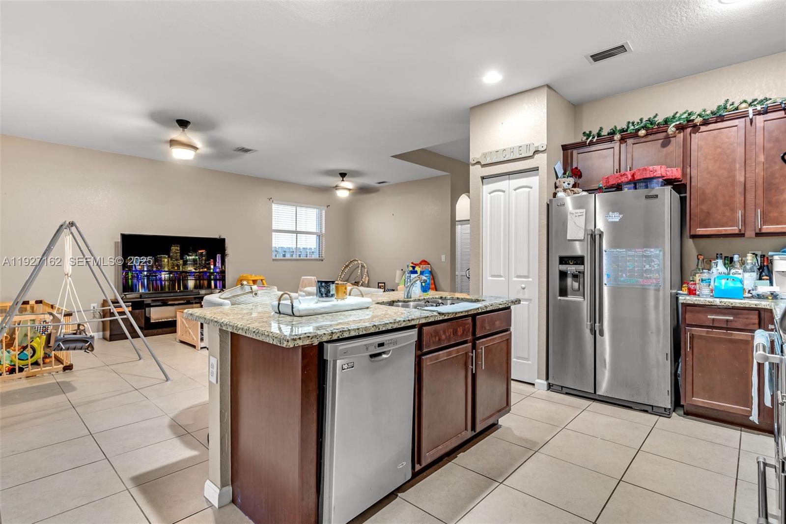 11833 Southwest 250th Terrace Homestead, FL 33032 - Photo 9 of 38 a kitchen with kitchen island granite countertop lots of counter top space and appliances