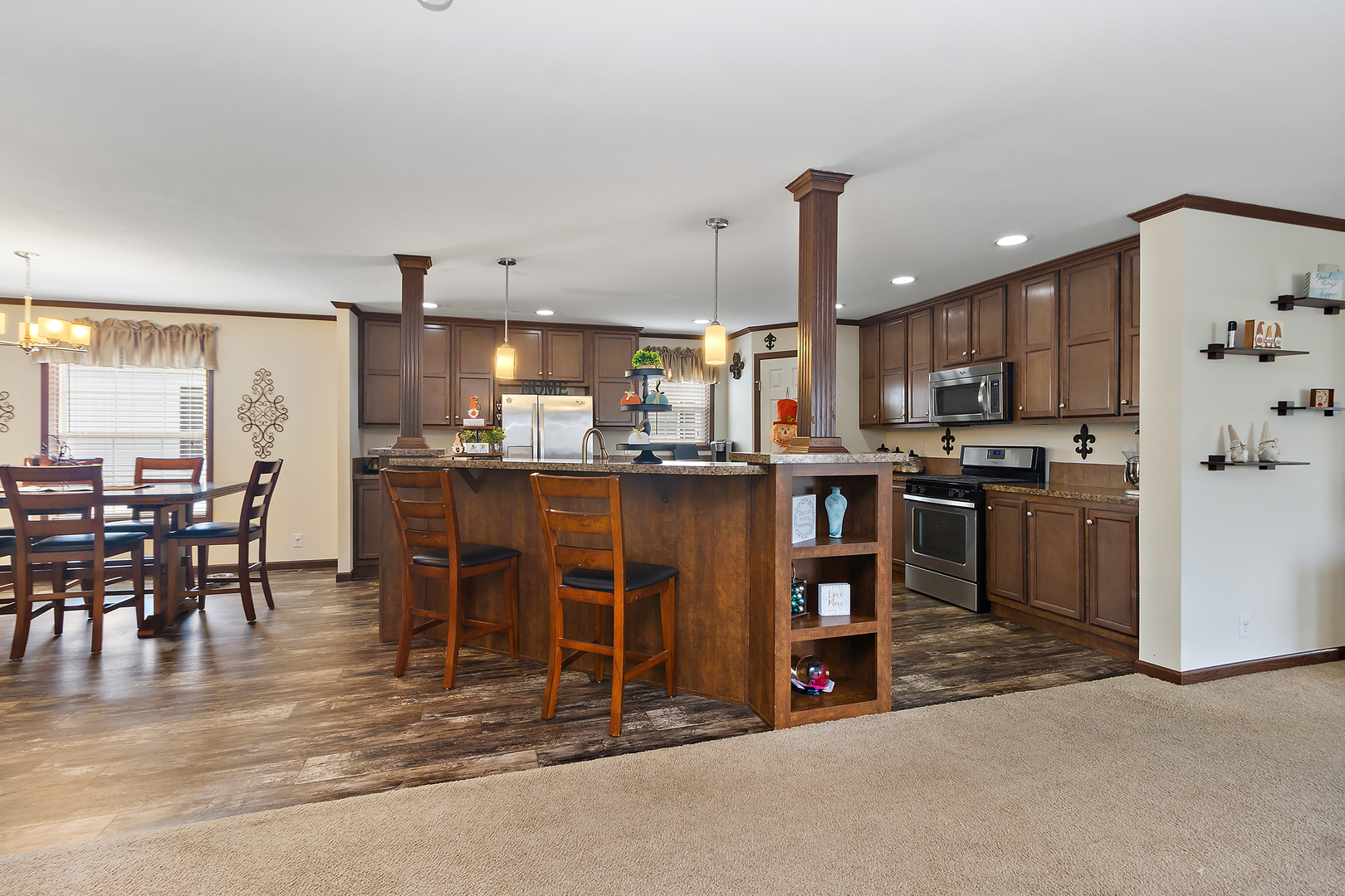 17 St Paul Bourbonnais, IL 60914 - Photo 2 of 16 a kitchen with stainless steel appliances kitchen island granite countertop a table chairs and a refrigerator