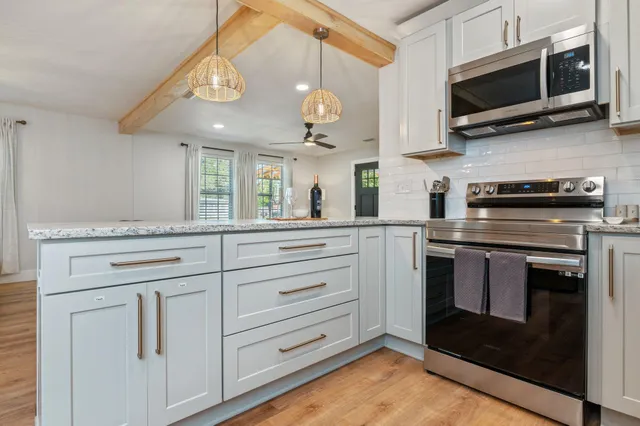 a spacious bedroom with a bed and a lamp