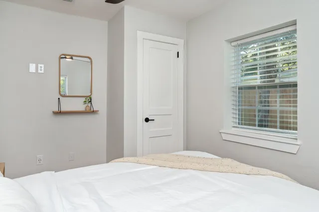 a bedroom with a bed and a flat tv screen