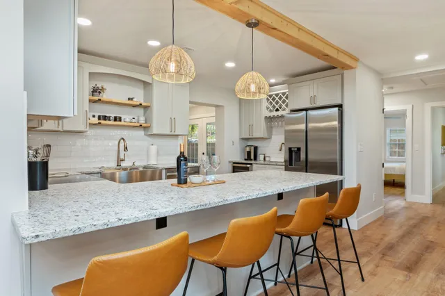 a bedroom with a bed and a lamp on the dresser