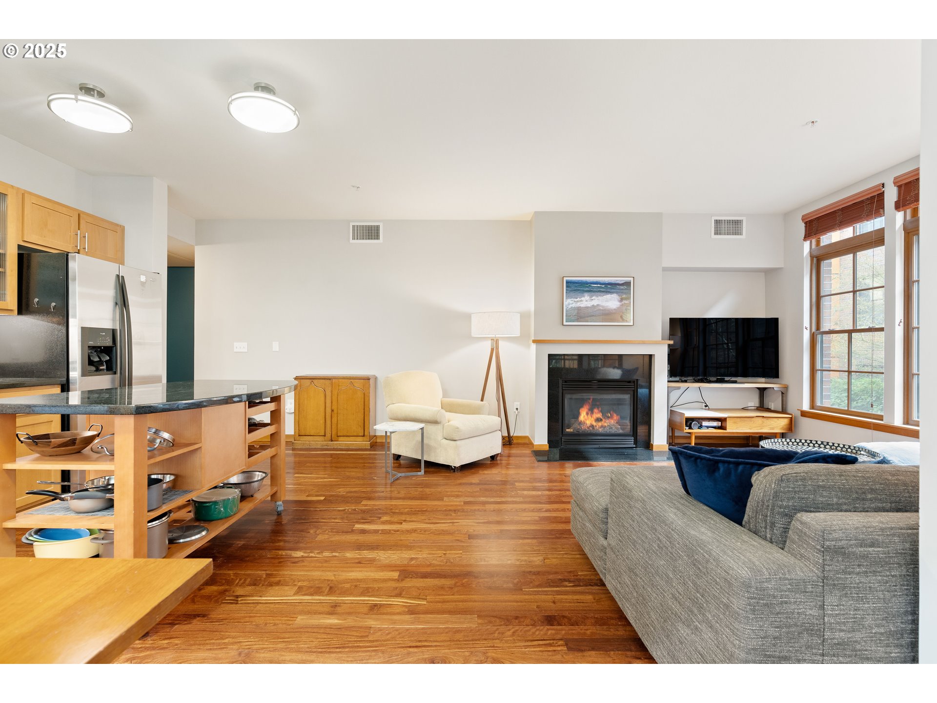 2350 Northwest Savier Street, Unit 202 Portland, OR 97210 - Photo 5 of 30 a living room with furniture flat screen tv and a fireplace