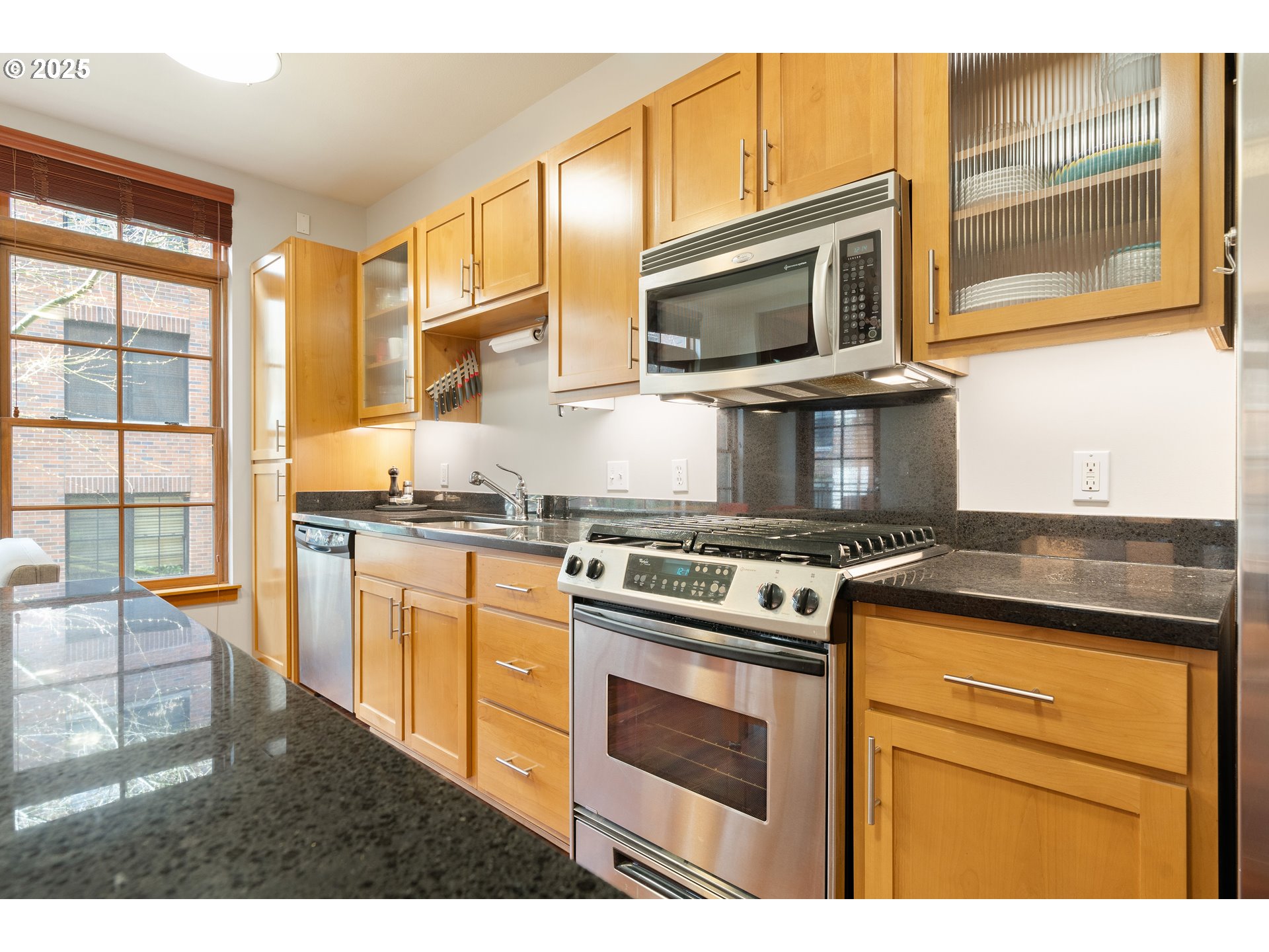 2350 Northwest Savier Street, Unit 202 Portland, OR 97210 - Photo 9 of 30 a kitchen with stainless steel appliances granite countertop a stove microwave and sink