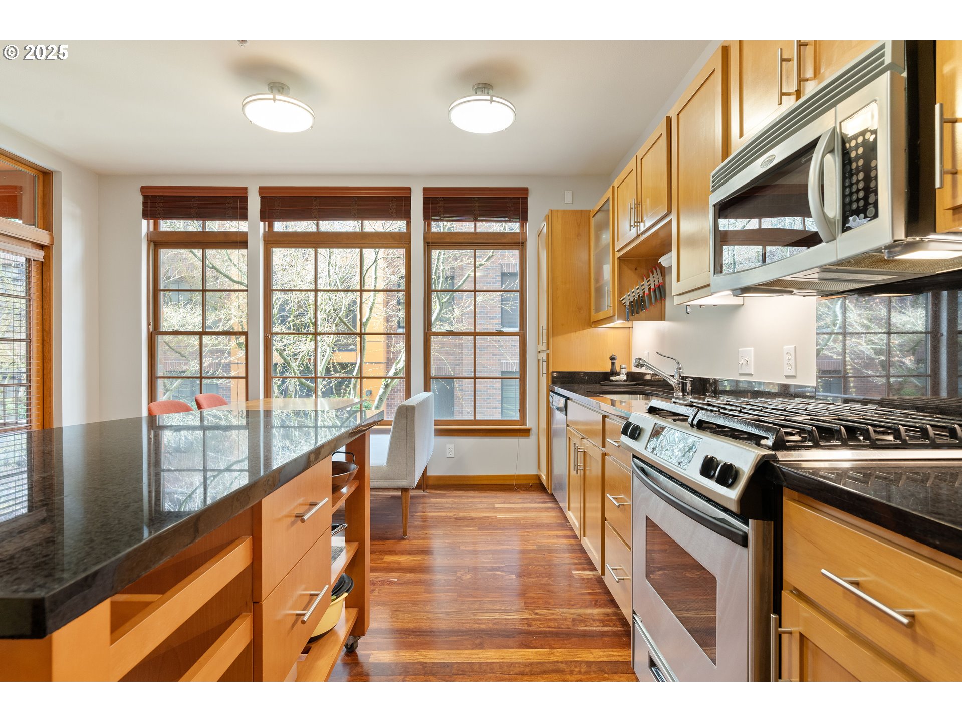 2350 Northwest Savier Street, Unit 202 Portland, OR 97210 - Photo 10 of 30 a kitchen with stainless steel appliances granite countertop a stove and a sink