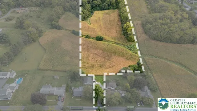 an aerial view of a residential houses with outdoor space