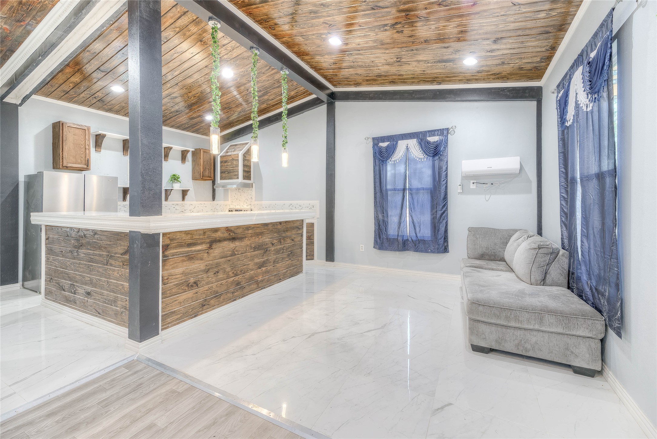 a living room with furniture and a chandelier